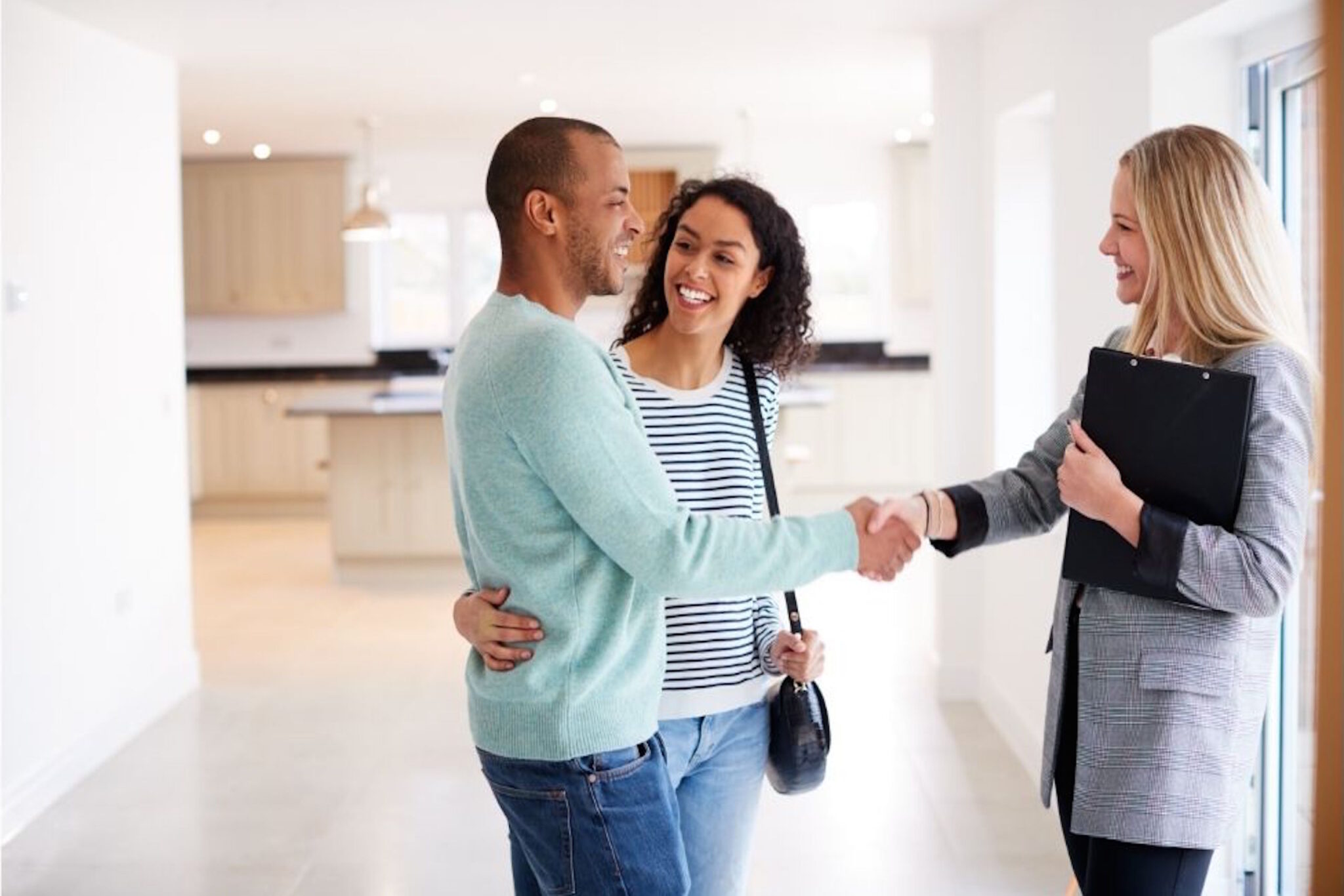 Woman shaking hands with possible home buyer